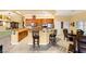 Open kitchen with wooden cabinets, granite countertops, and adjacent dining area offering a seamless living space at 5940 Vizzi Ct, Las Vegas, NV 89131