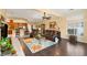 Spacious living room with wood-look tile, stylish furniture, open to the kitchen, and with natural light at 5940 Vizzi Ct, Las Vegas, NV 89131