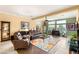 Comfortable living room boasts a floral rug, recliner seating, large windows and stylish decor at 5940 Vizzi Ct, Las Vegas, NV 89131