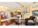 Open-concept living room and dining area with hardwood floors, ample natural light, and stylish furnishings at 5940 Vizzi Ct, Las Vegas, NV 89131