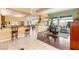 Open-concept living area featuring wood floors and seamless integration with the kitchen and dining area at 5940 Vizzi Ct, Las Vegas, NV 89131