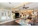 Inviting living area featuring a fireplace, access to outdoor patio, and a view of the kitchen at 5940 Vizzi Ct, Las Vegas, NV 89131