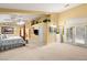 Large primary bedroom with a seating area, high ceilings, and access to a private balcony at 5940 Vizzi Ct, Las Vegas, NV 89131