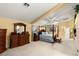 Comfortable main bedroom with a four-poster bed, dresser, and ensuite bathroom at 5940 Vizzi Ct, Las Vegas, NV 89131