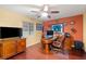 Inviting home office with ceiling fan, sports-themed decor, and wood floors at 5940 Vizzi Ct, Las Vegas, NV 89131