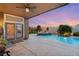 Outdoor covered patio with pool and spa, framed by mature palm trees and manicured shrubbery at 5940 Vizzi Ct, Las Vegas, NV 89131