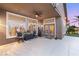 Relaxing covered patio featuring ceiling fan and comfortable seating near windows and backyard at 5940 Vizzi Ct, Las Vegas, NV 89131