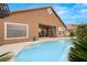 Back exterior showcasing pool, hot tub, covered patio, and desert landscaping at 5940 Vizzi Ct, Las Vegas, NV 89131