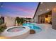 Sparkling pool and hot tub with lush tropical landscaping create a private backyard oasis at 5940 Vizzi Ct, Las Vegas, NV 89131