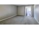 Bedroom with access to a private balcony, featuring neutral paint and modern carpet at 698 S Racetrack Rd # 1521, Henderson, NV 89015