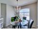 Cozy dining area with a chandelier and a round glass table by a window at 698 S Racetrack Rd # 1521, Henderson, NV 89015