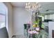 Bright dining area featuring a glass table and view into a modern kitchen with white cabinets at 698 S Racetrack Rd # 1521, Henderson, NV 89015