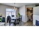 Cozy dining area with modern light fixture and a view to the laundry area at 698 S Racetrack Rd # 1521, Henderson, NV 89015