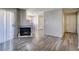 Open-concept living room with a stone fireplace, modern flooring, and plenty of natural light at 698 S Racetrack Rd # 1521, Henderson, NV 89015