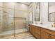 Contemporary bathroom with double vanity, walk-in shower with gold fixtures, and decorative tile at 800 Jody Brook Ct, Las Vegas, NV 89145