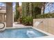 Relaxing hot tub with waterfall feature surrounded by lush landscaping at 800 Jody Brook Ct, Las Vegas, NV 89145
