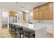 Kitchen with white cabinets, quartz countertops, stainless appliances, and island with barstool seating at 800 Jody Brook Ct, Las Vegas, NV 89145