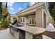 Outdoor kitchen with built-in grill, granite countertops, and covered patio at 800 Jody Brook Ct, Las Vegas, NV 89145