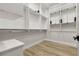Spacious walk-in closet with custom adjustable shelving, rods and wood floors at 800 Jody Brook Ct, Las Vegas, NV 89145