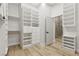 This beautiful walk-in closet has custom shelving, drawers, and a view of the bathroom at 800 Jody Brook Ct, Las Vegas, NV 89145