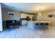 Spacious kitchen with white cabinets, marble flooring, and a large kitchen island with barstool seating at 9010 Eagle Wall Ct, Las Vegas, NV 89178