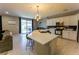 Bright open kitchen with stainless steel appliances, a large center island, and modern lighting fixtures at 9010 Eagle Wall Ct, Las Vegas, NV 89178