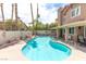 Backyard with a swimming pool, spa, mature trees, and a privacy wall at 94 Fantasia Ln, Henderson, NV 89074