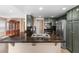 The kitchen features dark granite counters, green cabinets and stainless steel appliances at 94 Fantasia Ln, Henderson, NV 89074