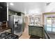 Renovated kitchen featuring modern appliances, granite countertops, and a breakfast bar with pool views at 94 Fantasia Ln, Henderson, NV 89074