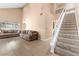 Spacious living room featuring high ceilings, tile floors and staircase at 94 Fantasia Ln, Henderson, NV 89074