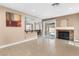 Open-concept living room with fireplace, tile flooring and backyard access at 94 Fantasia Ln, Henderson, NV 89074