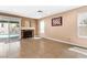 Cozy living room with fireplace, tile flooring, slider to backyard at 94 Fantasia Ln, Henderson, NV 89074