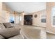 Open living room with large television, window, tile floor and sofa at 94 Fantasia Ln, Henderson, NV 89074