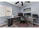 Home office with large desk, multiple monitors, and natural light at 94 Fantasia Ln, Henderson, NV 89074