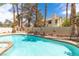 Inviting backyard pool with mature landscaping and perimeter hardscape at 94 Fantasia Ln, Henderson, NV 89074