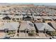 Expansive aerial view of a suburban neighborhood with mountain views, showcasing roof lines and community layout at 10126 Cliff Dwellings Ave, Las Vegas, NV 89178