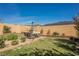Well-maintained backyard with lawn, flower beds, and outdoor seating area at 10126 Cliff Dwellings Ave, Las Vegas, NV 89178