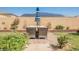 Cozy backyard patio with outdoor seating and landscaped flower beds at 10126 Cliff Dwellings Ave, Las Vegas, NV 89178