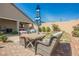 Backyard features a patio area with outdoor seating and a manicured lawn at 10126 Cliff Dwellings Ave, Las Vegas, NV 89178
