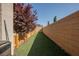 Narrow backyard showcasing artificial grass for low maintenance and a clean aesthetic at 10126 Cliff Dwellings Ave, Las Vegas, NV 89178