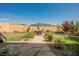 Spacious backyard featuring a brick patio, lawn, and mature landscaping at 10126 Cliff Dwellings Ave, Las Vegas, NV 89178