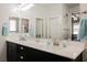 Bathroom featuring double vanity with a large mirror and recessed lighting at 10126 Cliff Dwellings Ave, Las Vegas, NV 89178