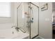 Bright bathroom featuring a glass-enclosed shower and soaking tub under a window at 10126 Cliff Dwellings Ave, Las Vegas, NV 89178