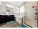 Modern bathroom with a glass-enclosed shower, a soaking tub, and stylish vanity at 10126 Cliff Dwellings Ave, Las Vegas, NV 89178