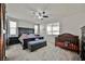 Bedroom with a ceiling fan, a bed, and a crib, with two windows providing natural light at 10126 Cliff Dwellings Ave, Las Vegas, NV 89178