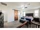 Bedroom featuring a sliding barn door to ensuite bathroom and ceiling fan with a king bed at 10126 Cliff Dwellings Ave, Las Vegas, NV 89178