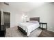 Neutral bedroom with a gray-toned bed, carpet, and side tables at 10126 Cliff Dwellings Ave, Las Vegas, NV 89178