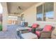 A cozy covered patio features brick flooring, comfortable seating, and ceiling fans for relaxed outdoor living at 10126 Cliff Dwellings Ave, Las Vegas, NV 89178