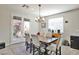 Bright dining room with stylish chandelier and access to the backyard at 10126 Cliff Dwellings Ave, Las Vegas, NV 89178
