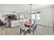 Dining room adjacent to living area, features stylish table and chairs at 10126 Cliff Dwellings Ave, Las Vegas, NV 89178